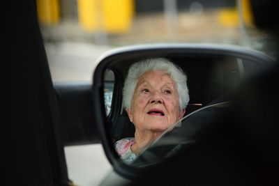 Portrait of old woman in car