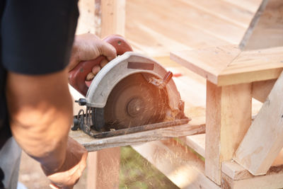 Man working ,carpenter saws wood, 