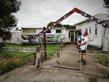 Full length of man outside house against sky