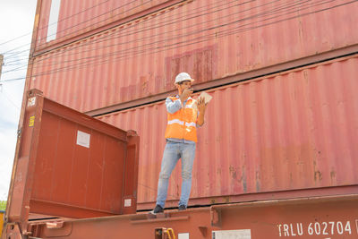 Low angle view of person standing against building