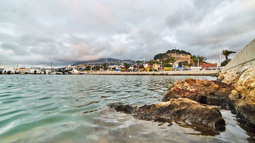 Scenic view of sea and buildings against sky