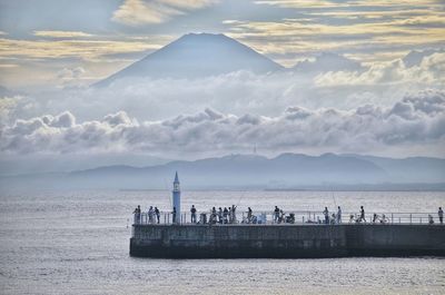 Scenic view of sea and mountains against sky