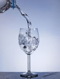 Close-up of wine glass against white background