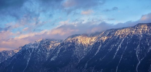 Scenic view of snowcapped mountains against sky during winter