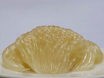 Close-up of lemon slice against white background