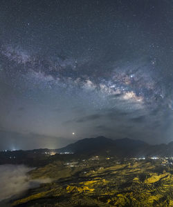 Scenic view of mountains against sky at night