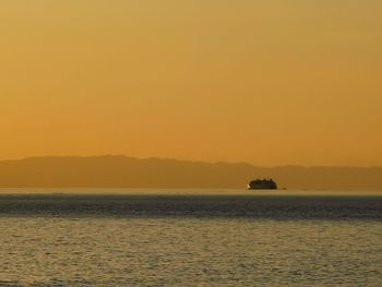 Scenic view of sea against orange sky