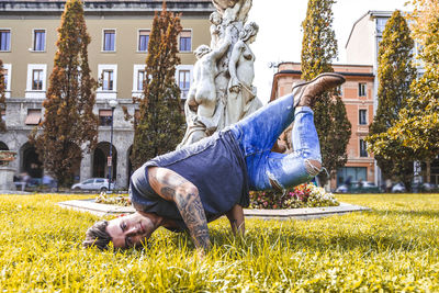 Statue against trees and buildings