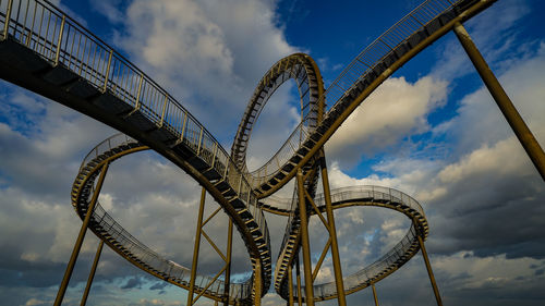 Low angle view of rollercoaster against sky