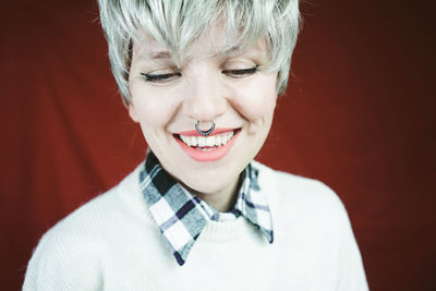 Close-up of happy mid adult woman with piercing