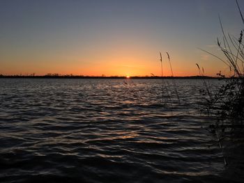 Scenic view of sea against clear sky during sunset