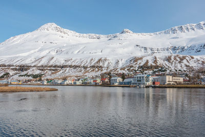 Scenic view of snowcapped mountains against blue sky