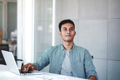 Portrait of young man using mobile phone