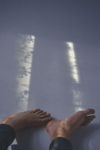 Low section of man against sky