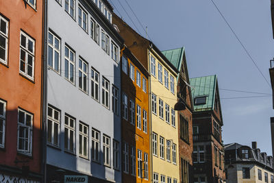 Low angle view of buildings against clear blue sky