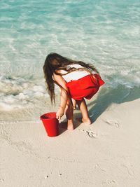 High angle view of girl playing at beach