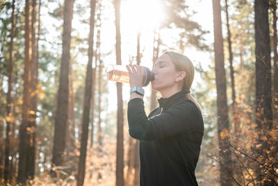 Man drinking water in forest