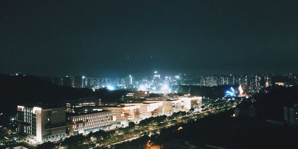 High angle view of illuminated buildings in city at night