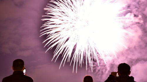 Low angle view of firework display at night