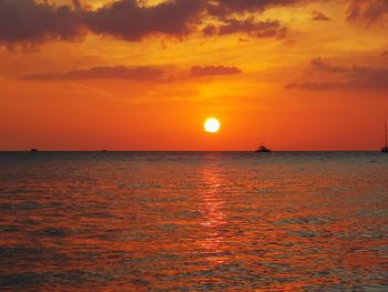 Scenic view of sea against romantic sky at sunset