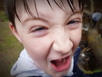 Close-up portrait of boy screaming outdoors