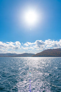 Scenic view of sea against sky on sunny day