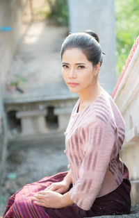 Portrait of woman sitting on staircase