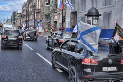 Cars on street amidst buildings in city