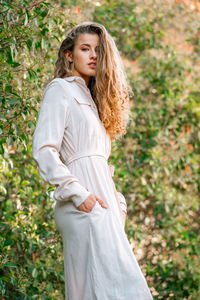 Portrait of young woman standing on land