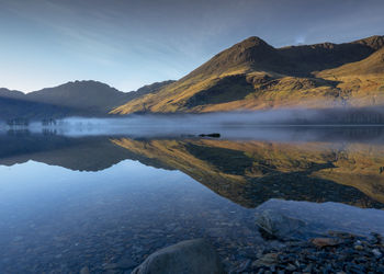 Scenic view of lake and mountains against sky