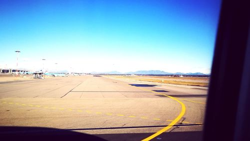 View of airport runway against clear sky