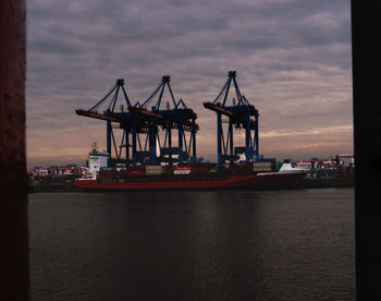 Boats in harbor at sunset