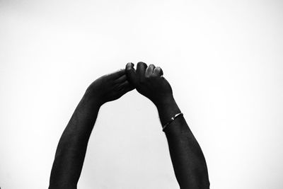 Close-up of woman hand against white background