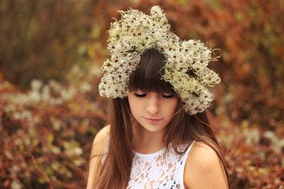 Sad young woman with flowers and bangs