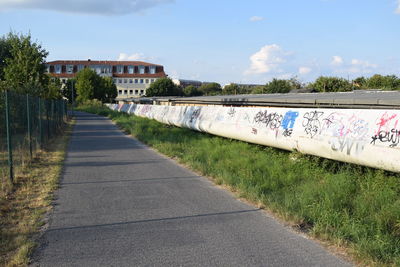 Road by building against sky