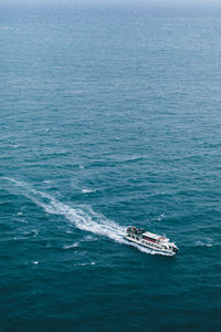 High angle view of boat sailing in sea against sky