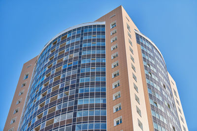 Low angle view of modern building against clear blue sky