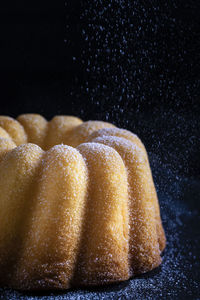 Close-up of cake against black background