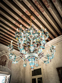 Low angle view of illuminated chandelier in building