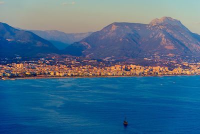 Scenic view of sea and mountains against sky