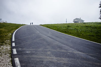 Road amidst buildings against sky