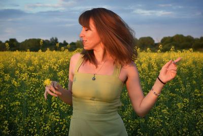 Young woman standing on field