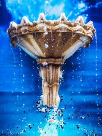 Close-up of splashing water against blue background