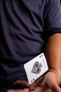 Midsection of man playing poker