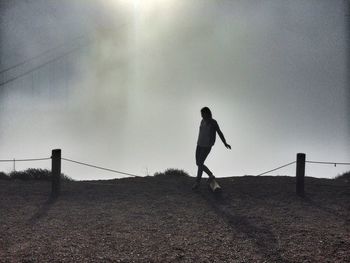 Full length of woman standing against sky