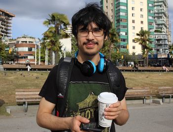 Portrait of young man holding camera