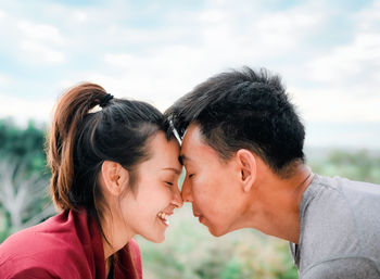 Side view of young couple face touching and smile, concept of couple relationship and valentine