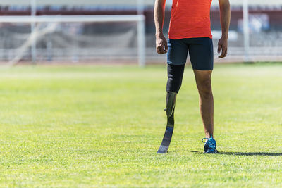 Low section of person playing soccer on field