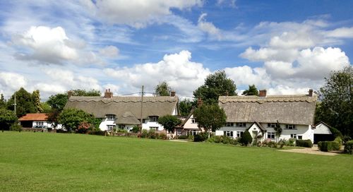 Houses on field against sky