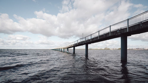 Bridge over sea against sky